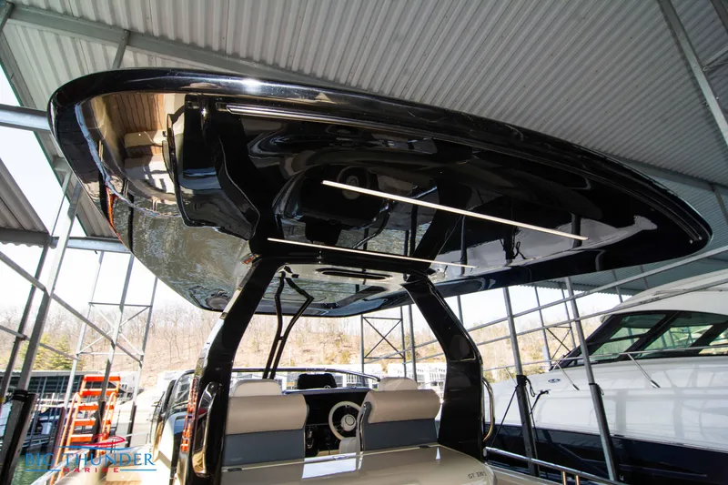 Slide: The Image of 2024 Invictus GT370S boat under a metal canopy at a marina. - 23