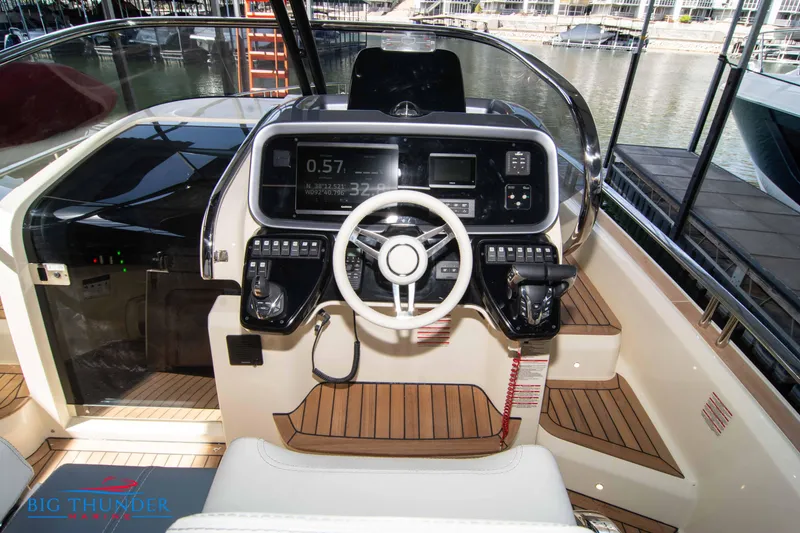 Slide: The Image of 2024 Invictus GT370S yacht cockpit with modern steering and control panel. - 24