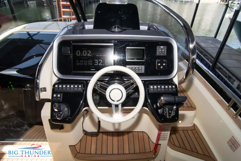 Slide: The Image of 2024 Invictus GT370S boat dashboard with modern controls and steering wheel. - 25