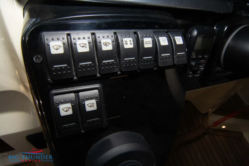 Slide: The Image of Control panel of 2024 Invictus GT370S boat with labeled switches and radio. - 33