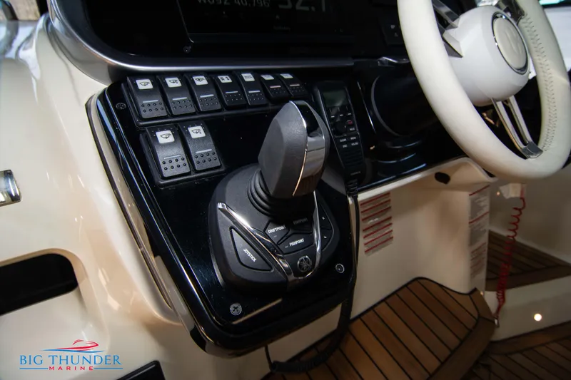 Slide: The Image of 2024 Invictus GT370S boat cockpit with joystick control and steering wheel, Big Thunder Marine logo. - 37
