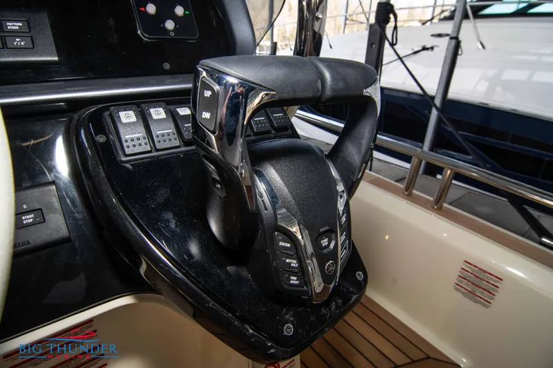 Slide: The Image of 2024 Invictus GT370S yacht control panel with advanced steering and navigation features. - 38