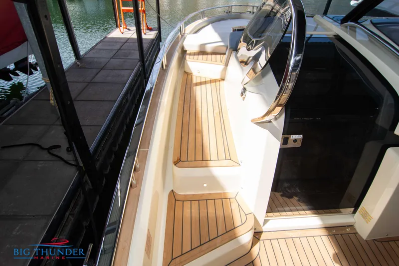 Slide: The Image of 2024 Invictus GT370S yacht with sleek wooden deck and modern design. - 43