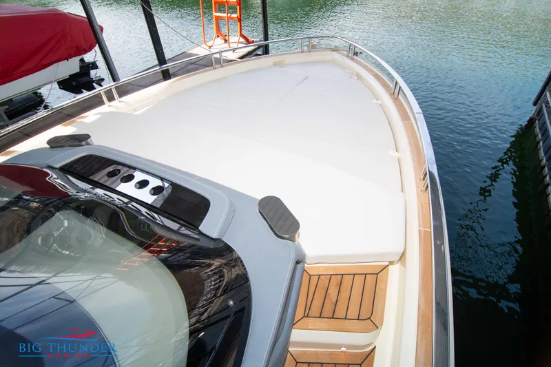 Slide: The Image of 2024 Invictus GT370S luxury yacht with spacious deck and sleek design at marina. - 45