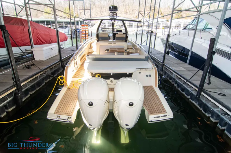 Slide: The Image of 2024 Invictus GT370S luxury boat docked, showcasing sleek design and powerful engines. - 5