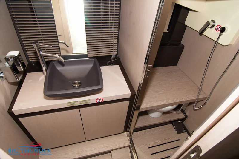 Slide: The Image of 2024 Invictus GT370S bathroom with modern sink and shower area. - 52