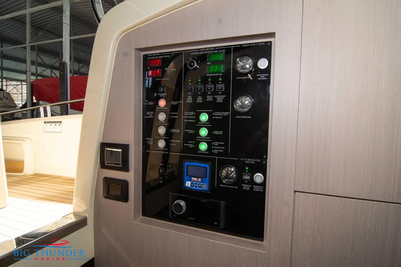 Slide: The Image of Control panel of 2024 Invictus GT370S yacht, featuring various gauges and switches. - 56