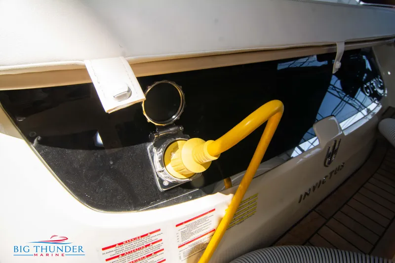 Slide: The Image of 2024 Invictus GT370S yacht with yellow power cable connection at Big Thunder Marine. - 7