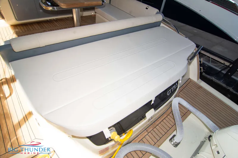 Slide: The Image of 2024 Invictus GT370S yacht deck with seating and table, featuring teak flooring. - 9
