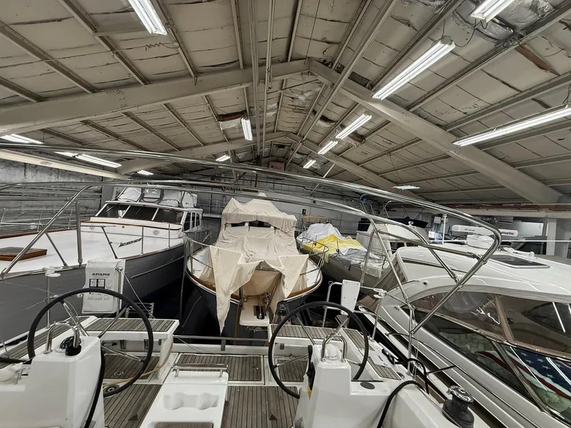 Slide: The Image of Indoor storage of multiple boats, including a 2017 Beneteau Oceanis 38.1 sailboat. - 13