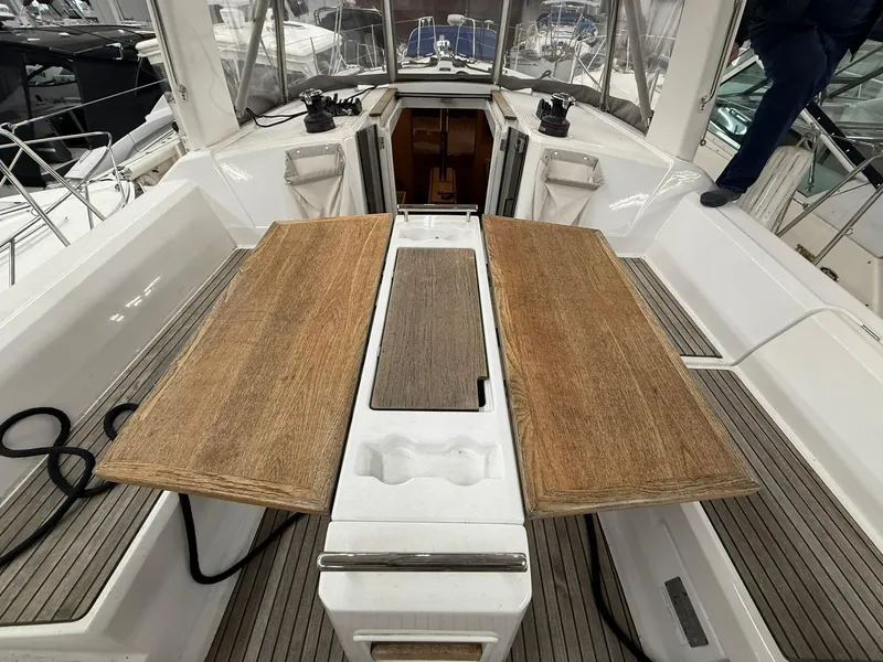 Slide: The Image of Cockpit of 2017 Beneteau Oceanis 38.1 sailboat with wooden table and seating. - 19