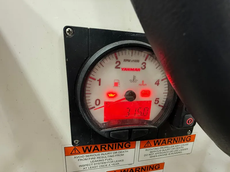 Slide: The Image of Yanmar engine tachometer on 2017 Beneteau Oceanis 38.1 sailboat, displaying RPM and warning labels. - 21