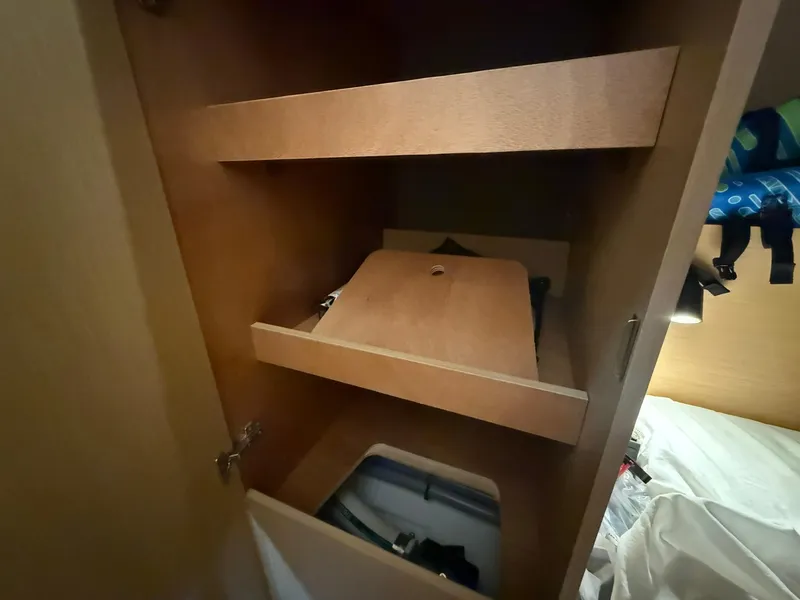 Slide: The Image of Wooden storage shelves inside a 2017 Beneteau Oceanis 38.1 yacht cabin. - 32