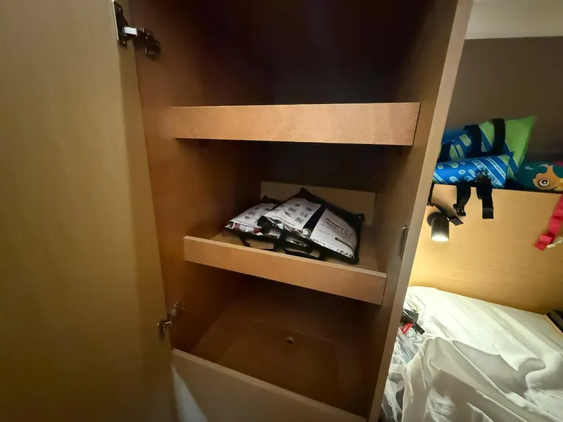 Slide: The Image of Cabin storage in 2017 Beneteau Oceanis 38.1 yacht with shelves and bedding. - 33