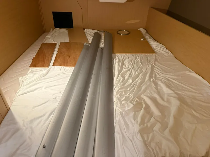 Slide: The Image of Interior of 2017 Beneteau Oceanis 38.1 yacht with wooden panels and metal poles. - 35