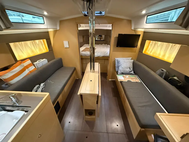 Slide: The Image of Interior of 2017 Beneteau Oceanis 38.1 sailboat, featuring cozy seating and modern amenities. - 39