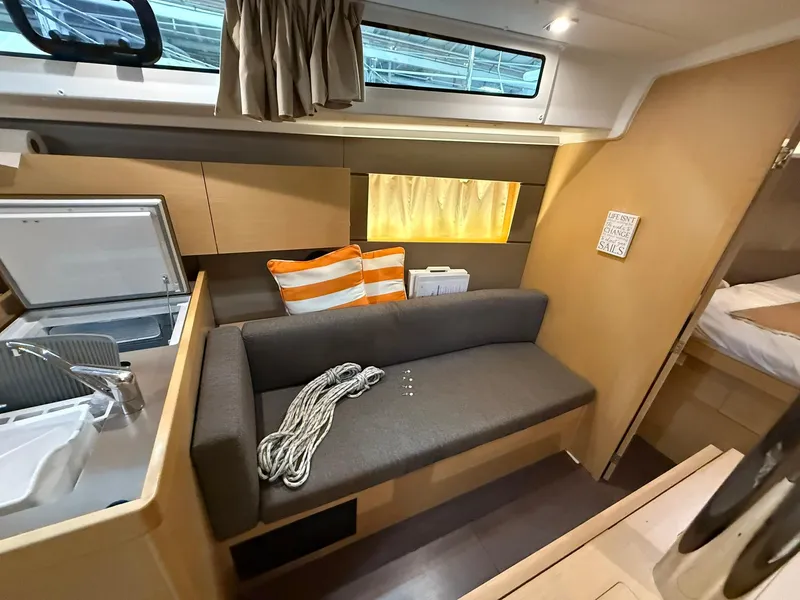 Slide: The Image of 2017 Beneteau Oceanis 38.1 interior with sofa, rope, and striped pillow. - 40