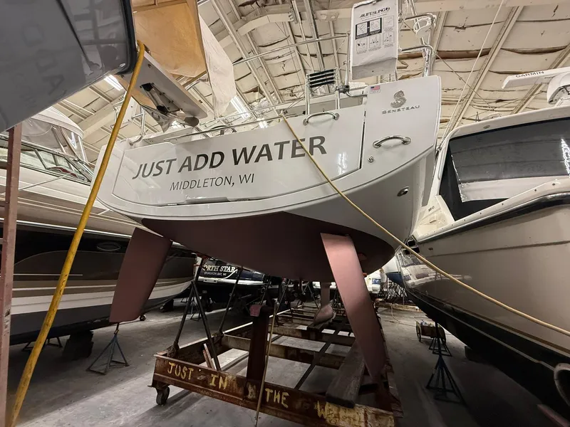 Slide: The Image of 2017 Beneteau Oceanis 38.1 sailboat in storage, labeled "Just Add Water," Middleton, WI. - 43