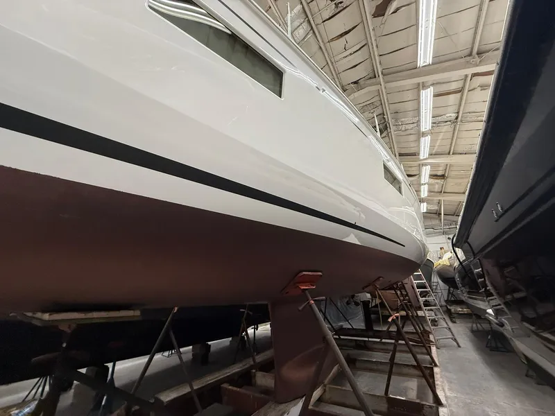Slide: The Image of 2017 Beneteau Oceanis 38.1 sailboat in a shipyard, viewed from below. - 48