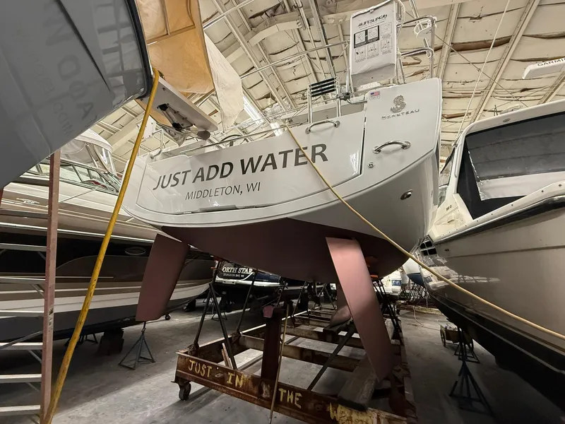 Slide: The Image of 2017 Beneteau Oceanis 38.1 sailboat in storage, labeled "Just Add Water," Middleton, WI. - 51