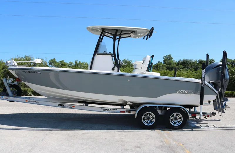 Slide: The Image of 2023 Pathfinder 2400TRS boat on trailer, side view, outdoors, clear sky. - 1