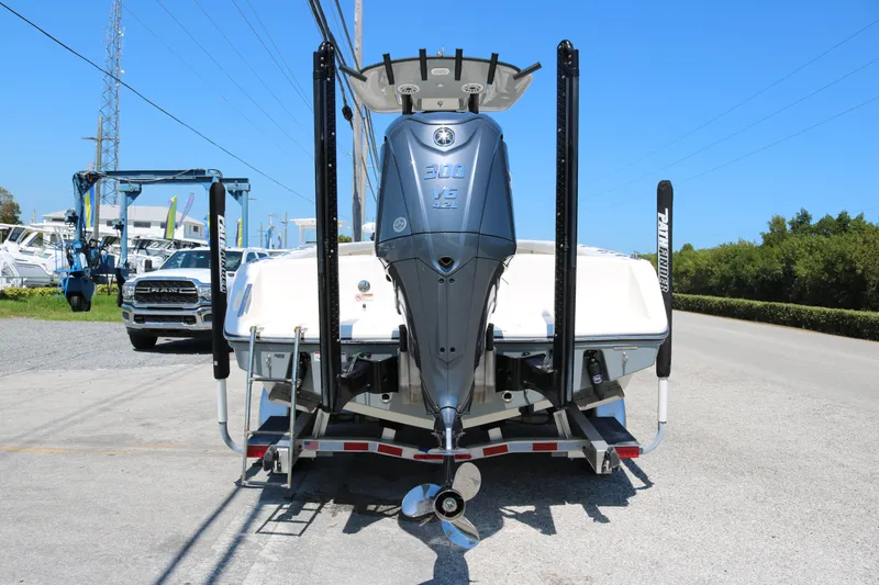 Slide: The Image of 2023 Pathfinder 2400TRS boat with powerful outboard motor, parked on a trailer. - 2