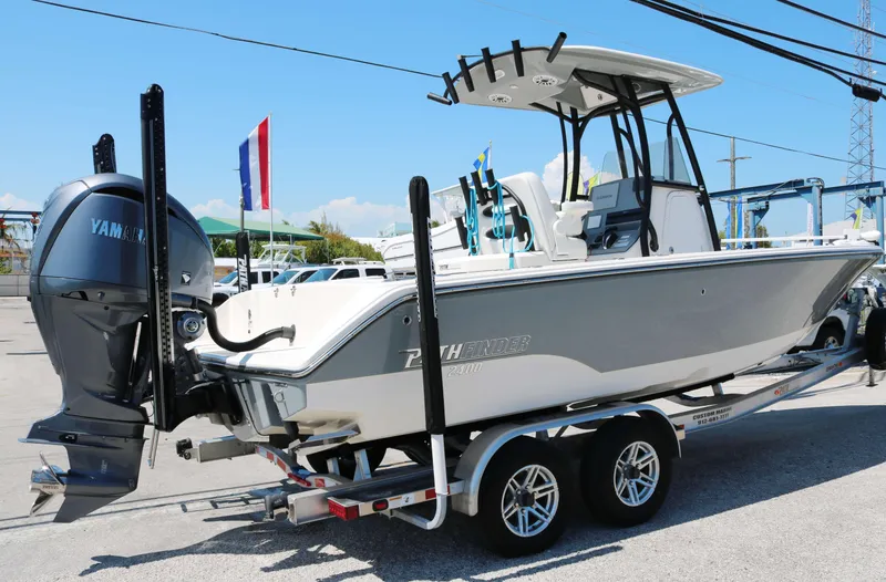 Slide: The Image of 2023 Pathfinder 2400TRS boat on trailer with Yamaha outboard motor, parked outdoors. - 3