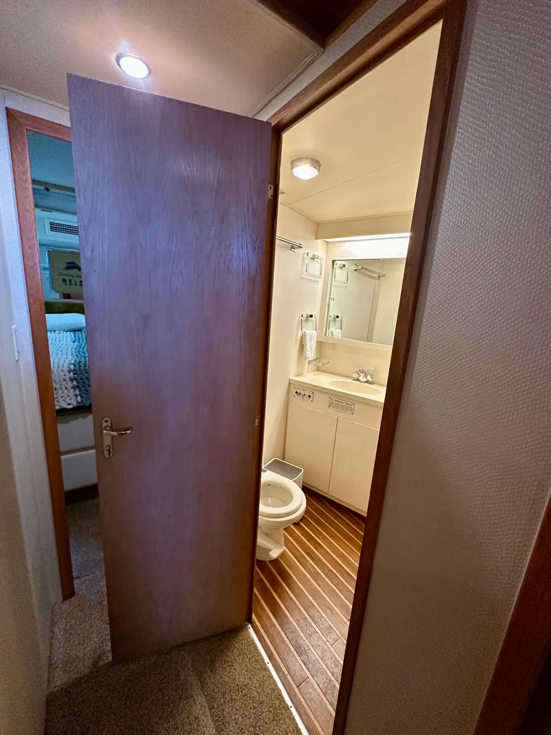 Slide: The Image of Bathroom interior of 1994 Hatteras 46 Convertible yacht, featuring wood flooring and modern fixtures. - 105