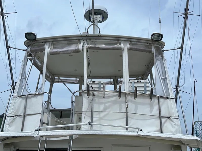 Slide: The Image of 1994 Hatteras 46 Convertible yacht with enclosed flybridge, featuring radar and antennas. - 12