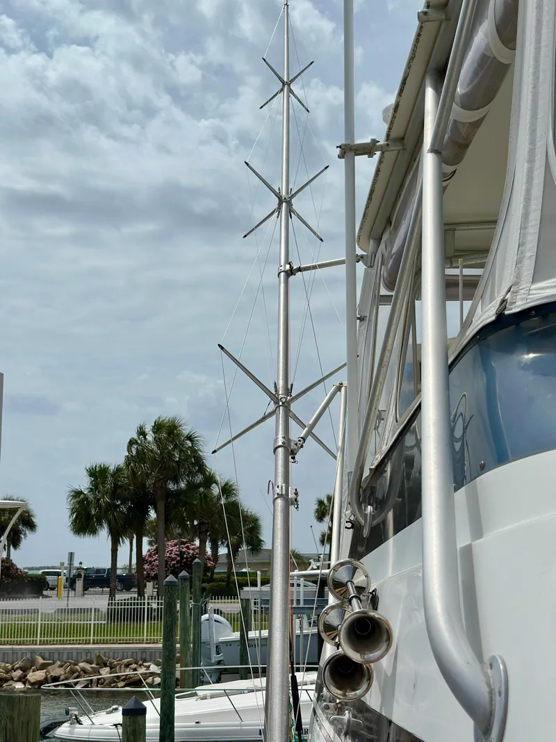 Slide: The Image of 1994 Hatteras 46 Convertible yacht with antennas docked at marina. - 13