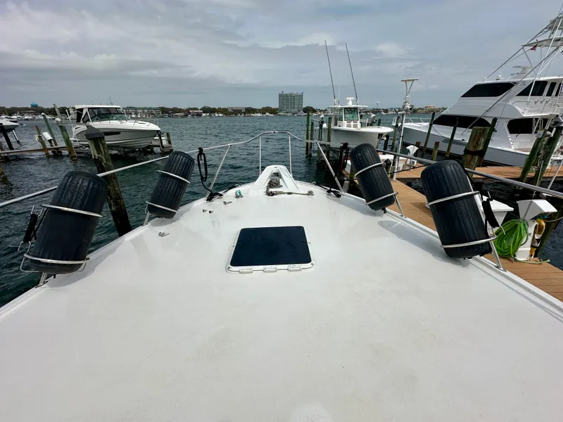 Slide: The Image of Bow view of 1994 Hatteras 46 Convertible yacht docked at marina. - 15