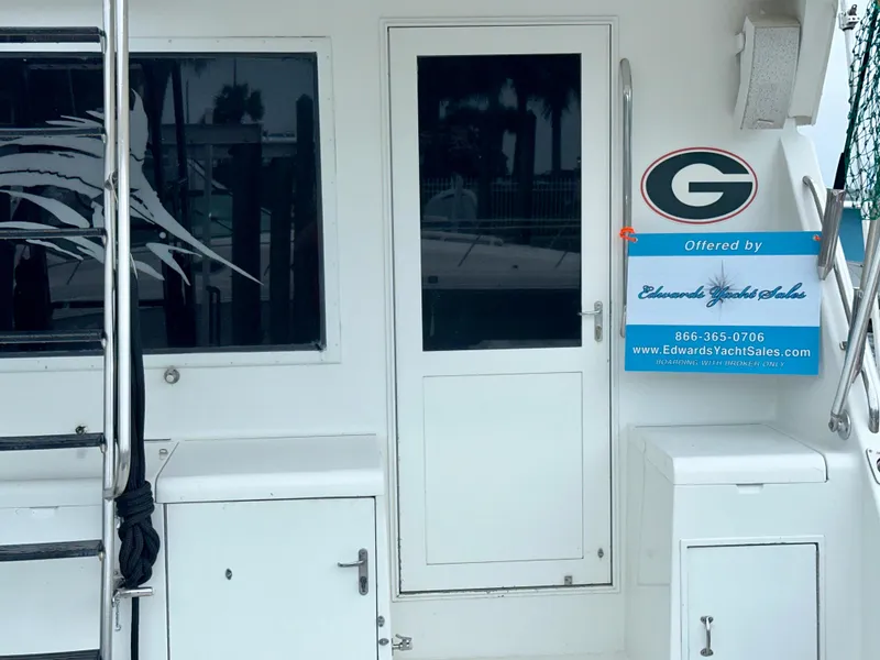 Slide: The Image of 1994 Hatteras 46 Convertible yacht with sales sign on deck. - 18