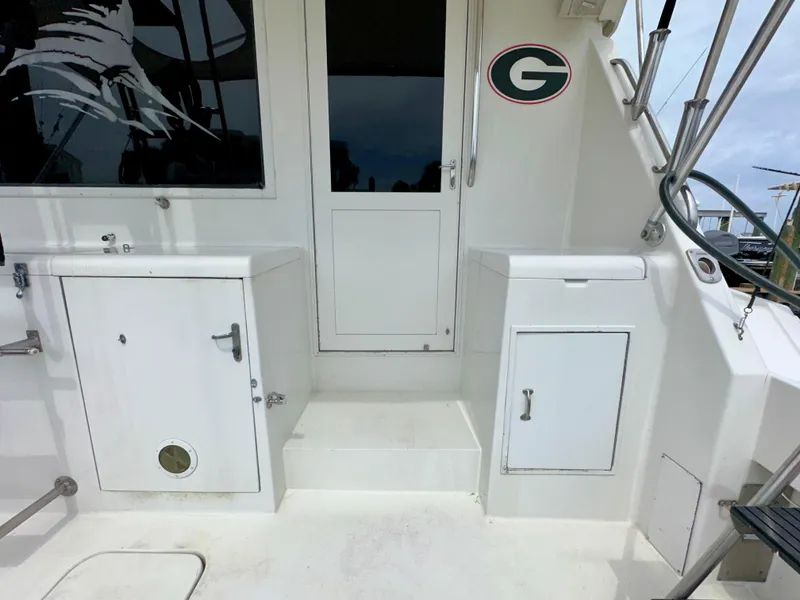 Slide: The Image of 1994 Hatteras 46 Convertible boat deck with storage compartments and door. - 20