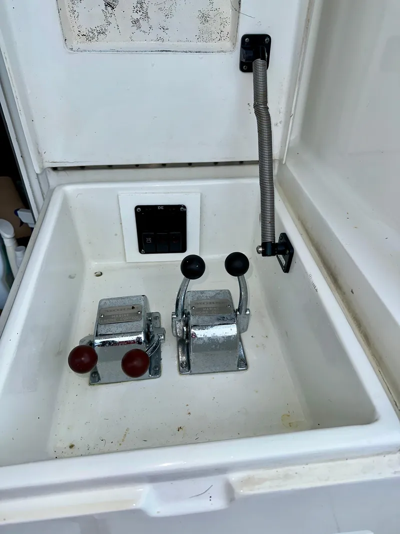 Slide: The Image of 1994 Hatteras 46 Convertible boat controls in a white compartment. - 22