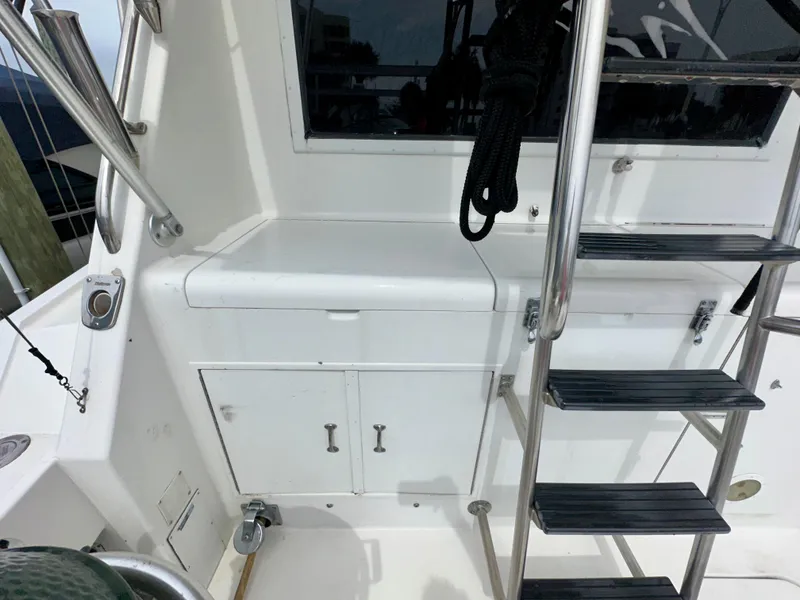 Slide: The Image of 1994 Hatteras 46 Convertible yacht deck with ladder and storage compartments. - 23