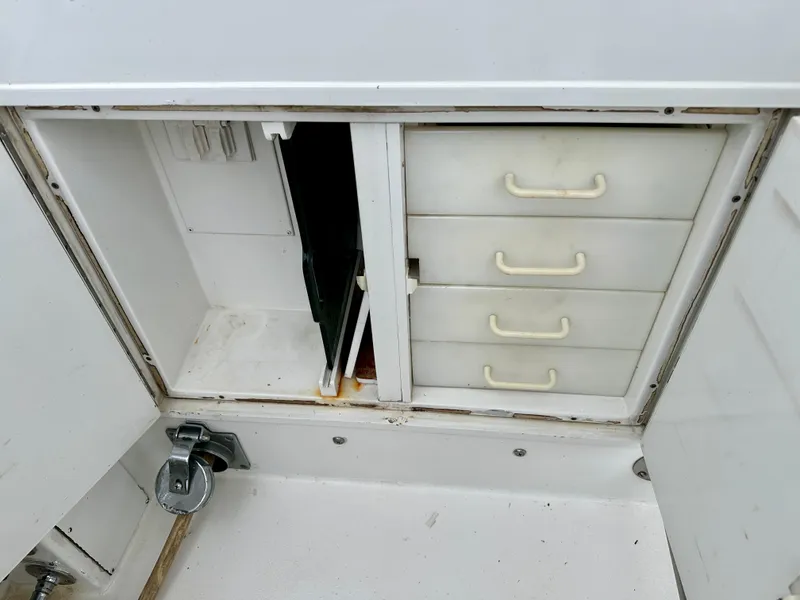 Slide: The Image of Storage compartment with drawers on a 1994 Hatteras 46 Convertible boat. - 25