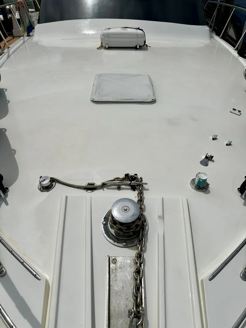 Slide: The Image of 1994 Hatteras 46 Convertible yacht deck with anchor chain and hatch. - 27