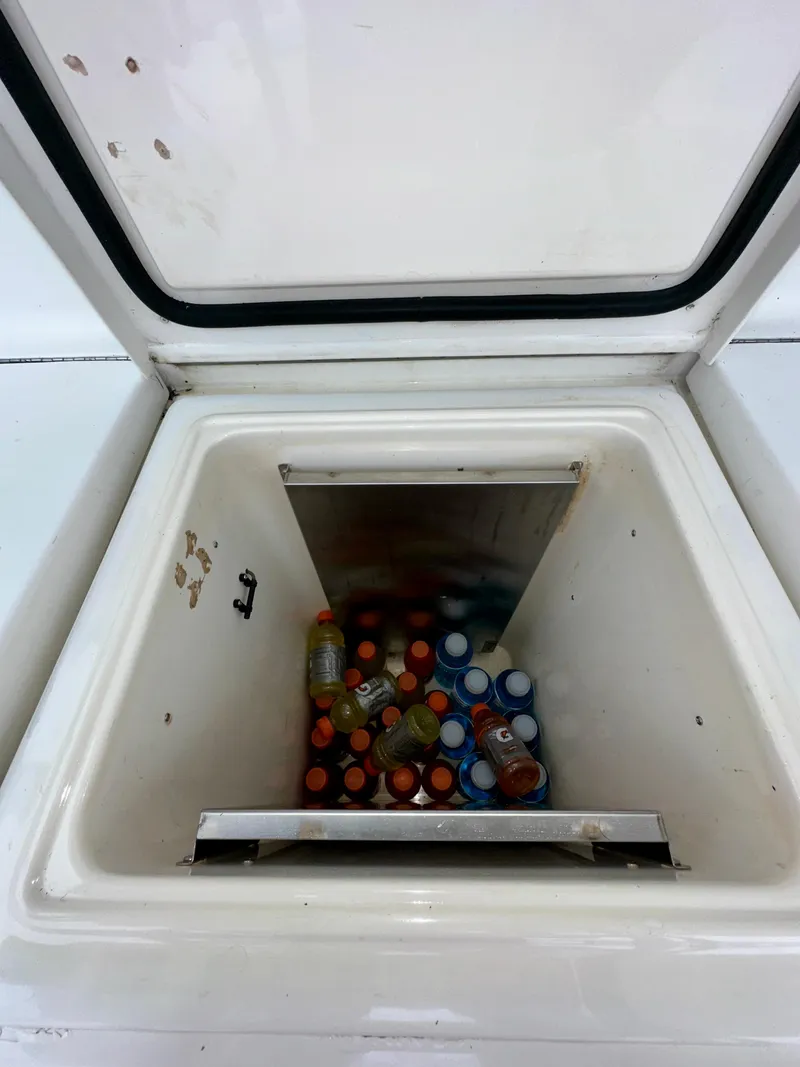 Slide: The Image of Cooler on 1994 Hatteras 46 Convertible boat filled with assorted bottled drinks. - 30