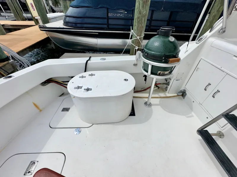 Slide: The Image of 1994 Hatteras 46 Convertible boat deck with grill and storage compartments. - 31