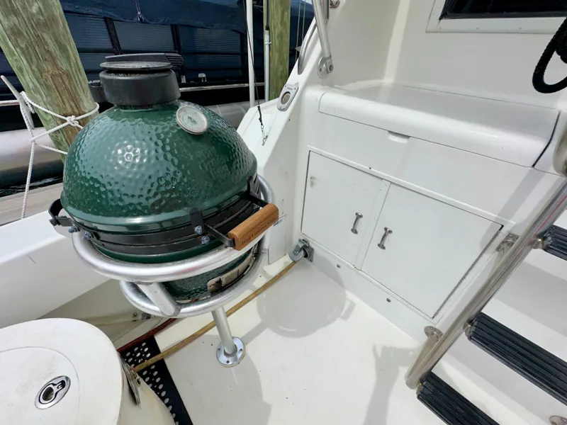 Slide: The Image of Outdoor grill on 1994 Hatteras 46 Convertible yacht deck, near storage cabinets and steps. - 32