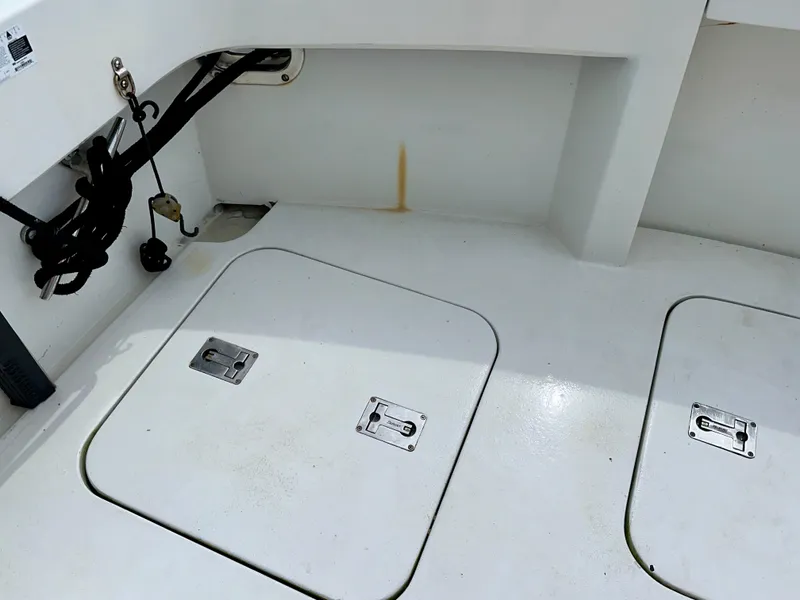 Slide: The Image of 1994 Hatteras 46 Convertible boat deck with storage hatches and utility cables. - 34