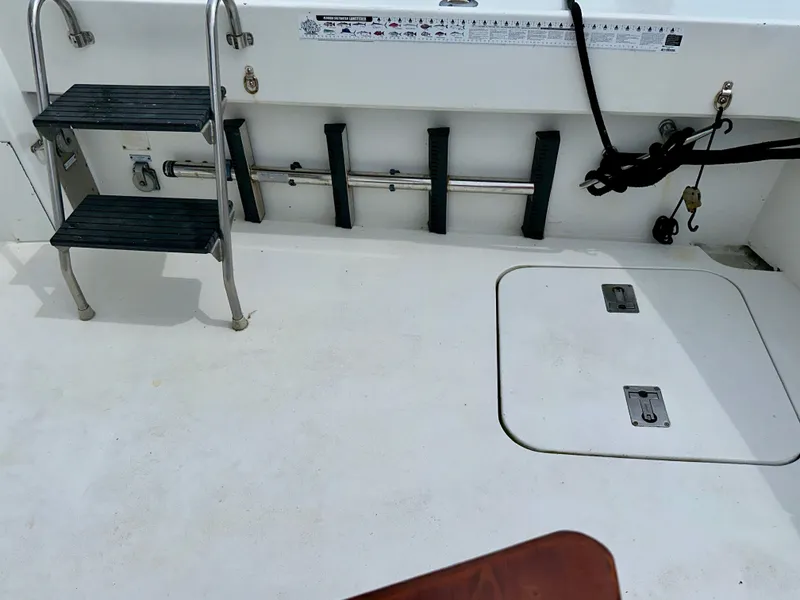 Slide: The Image of 1994 Hatteras 46 Convertible boat deck with ladder and storage compartments. - 36