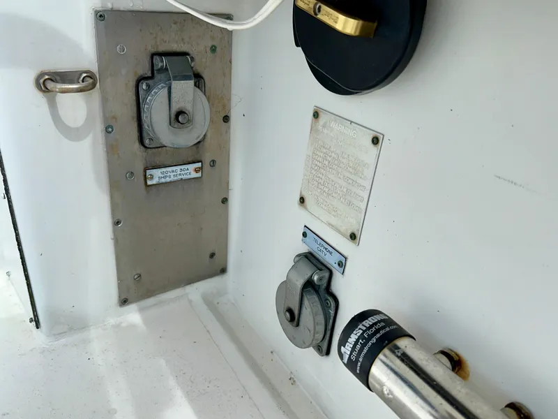 Slide: The Image of Electrical panel on a 1994 Hatteras 46 Convertible boat, featuring various connectors and labels. - 37
