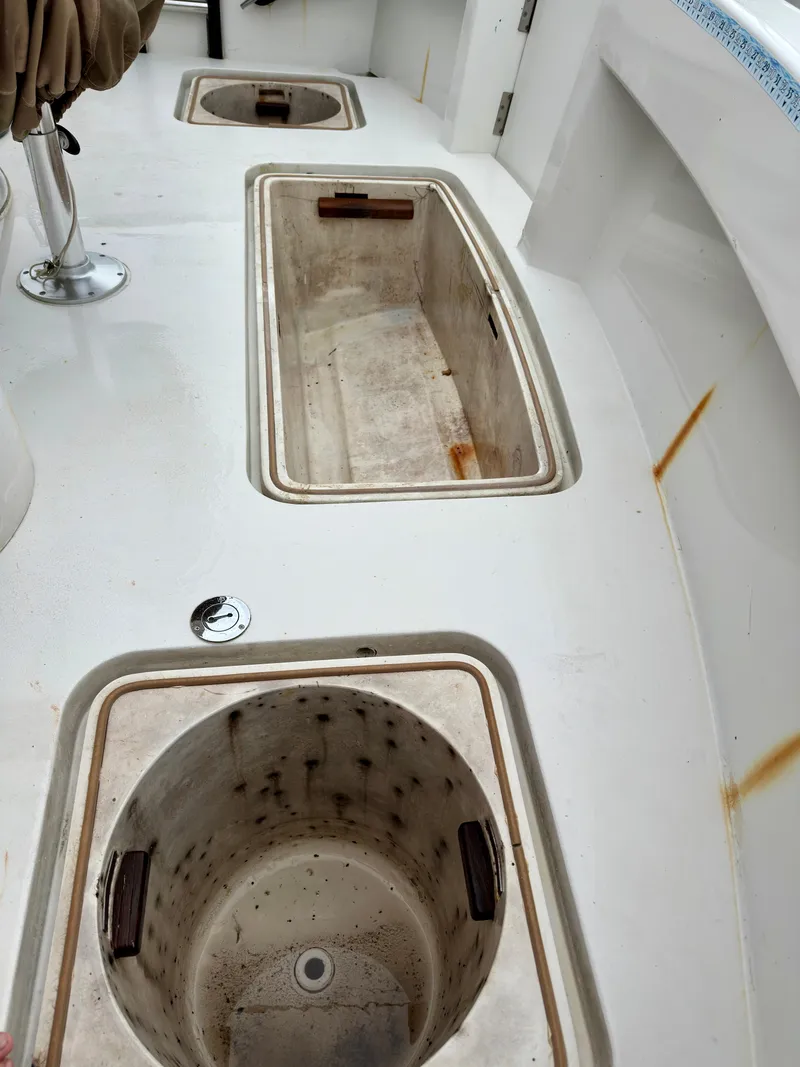 Slide: The Image of 1994 Hatteras 46 Convertible boat deck with storage compartments. - 38