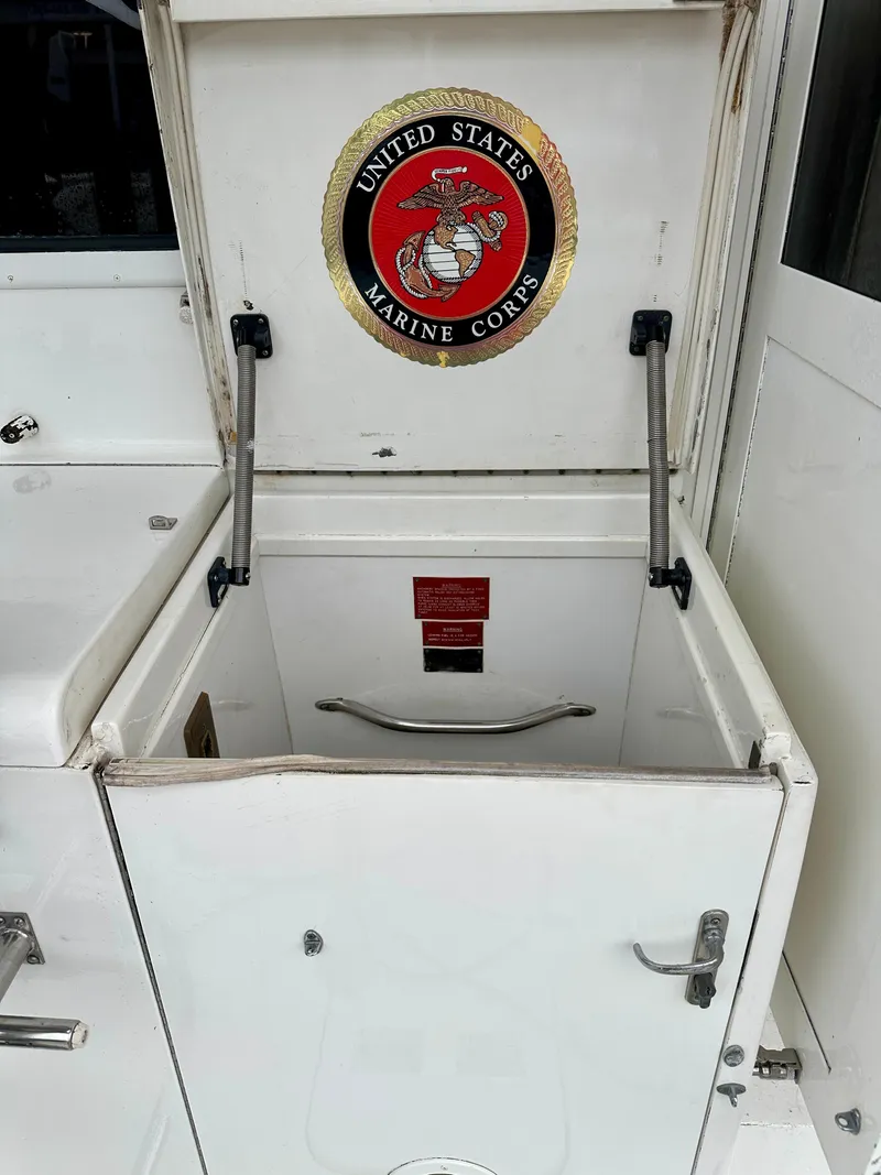 Slide: The Image of Open storage compartment on 1994 Hatteras 46 Convertible with United States Marine Corps emblem. - 40
