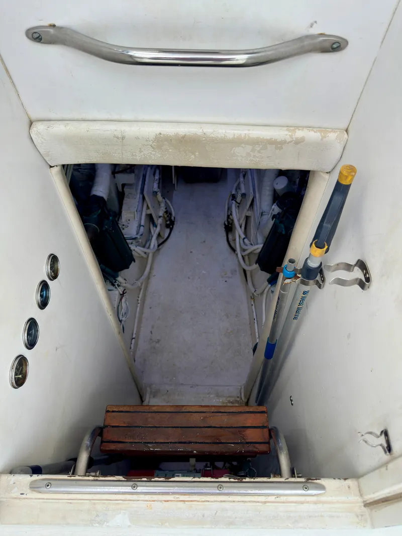 Slide: The Image of Engine room access on 1994 Hatteras 46 Convertible yacht, featuring steps and equipment storage. - 41