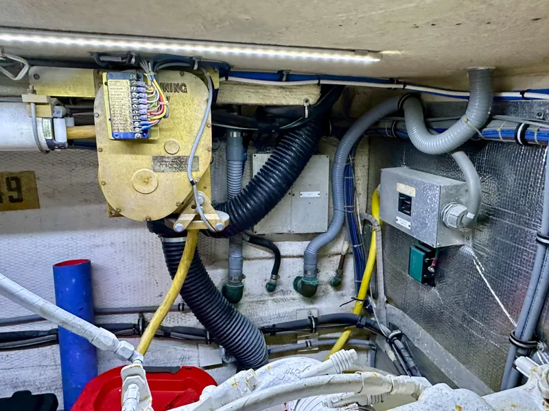 Slide: The Image of Engine room of 1994 Hatteras 46 Convertible with wiring and mechanical components. - 45