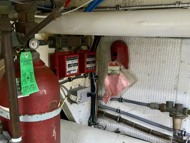 Slide: The Image of Engine room of 1994 Hatteras 46 Convertible with fire suppression system and control panel. - 46