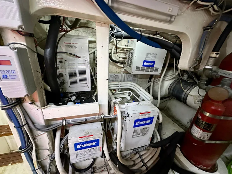 Slide: The Image of Engine room of 1994 Hatteras 46 Convertible with electrical systems and fire extinguisher. - 48
