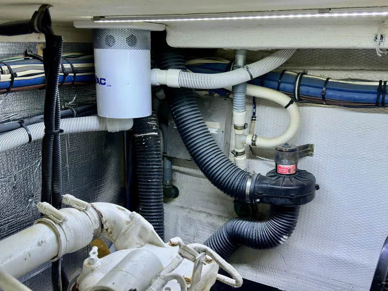 Slide: The Image of Engine room of 1994 Hatteras 46 Convertible with hoses and filter system. - 49
